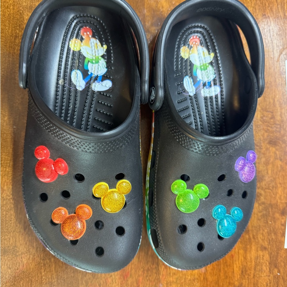 Disney CROCS Black and multi color with attached charms. Like new